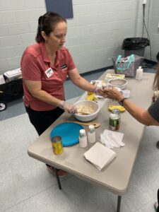 Chrissy serving food samples